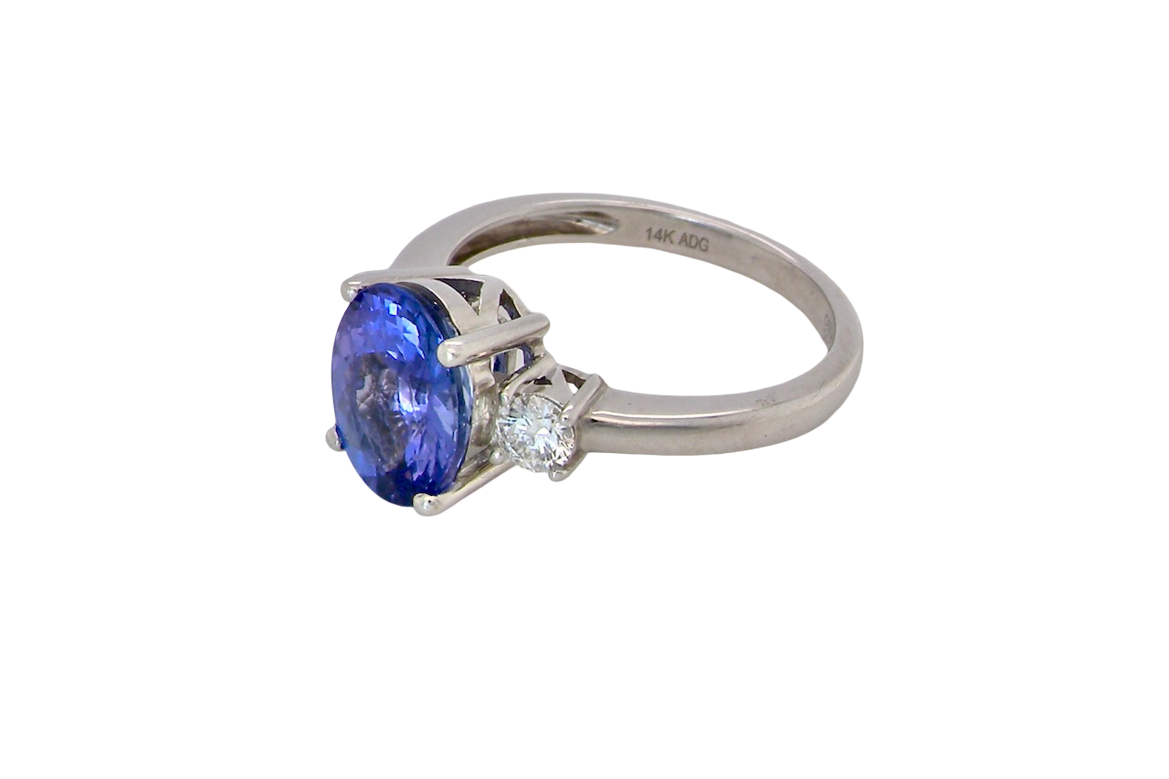A three stone ring that features an impressive tanzanite centre stone that measures 10x8mm (3.21 carats confirmed) AAA colour. side