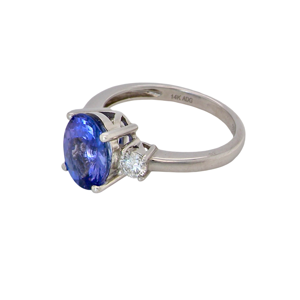A three stone ring that features an impressive tanzanite centre stone that measures 10x8mm (3.21 carats confirmed) AAA colour. side