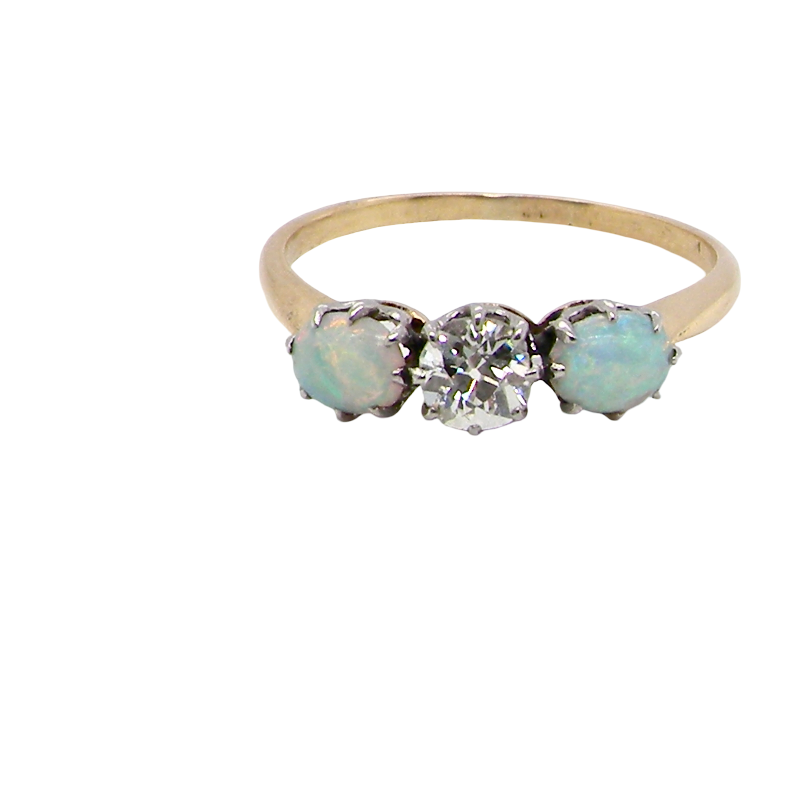 A three stone ring, the centre stone an old brilliant cut white diamond 4.6mm (est 0.38 carats) colour i-j, clarity Si, claw set in platinum.opal