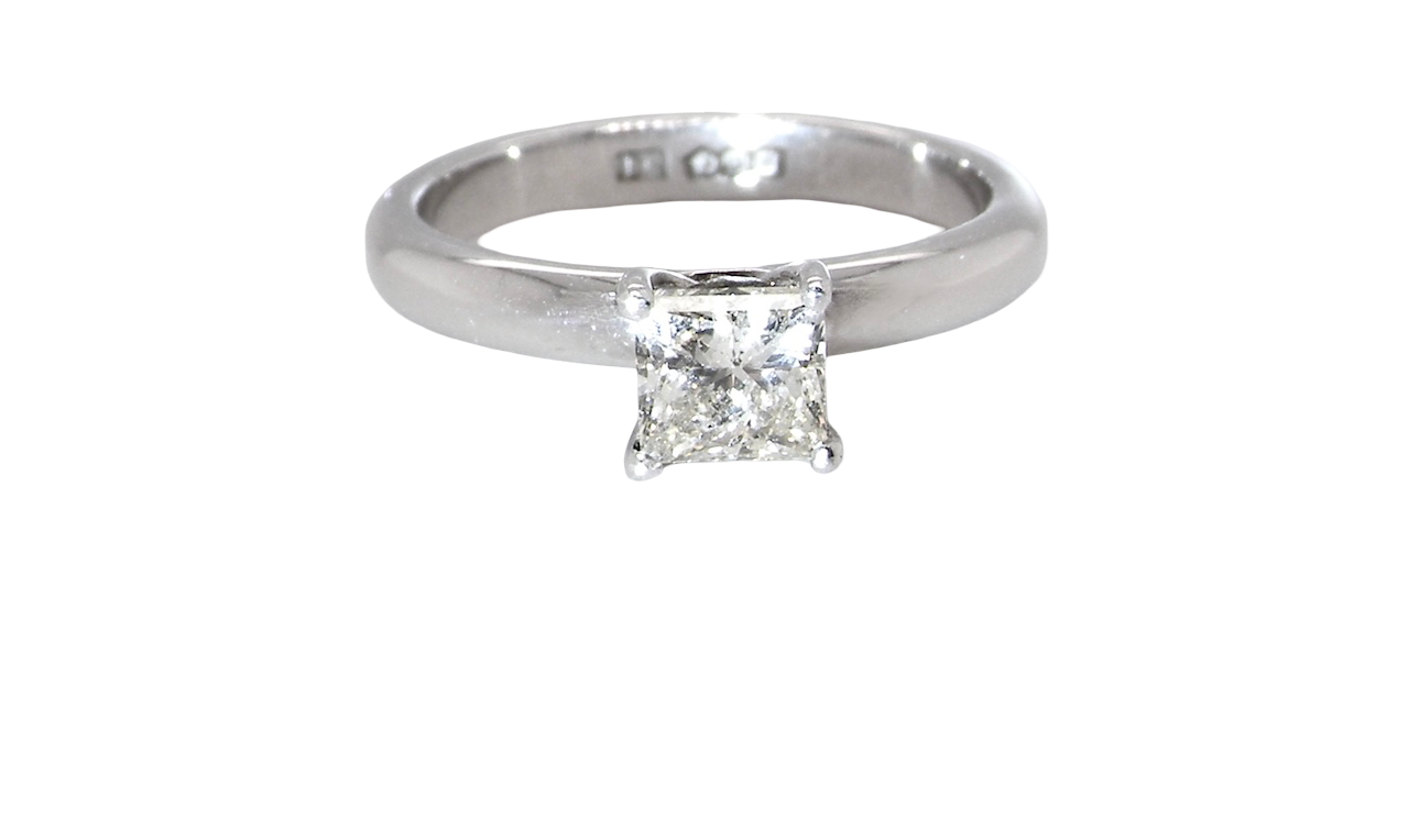 A timeless and beautifully crafted solitaire ring featuring a stunning 0.78 carat Princess-cut white diamond