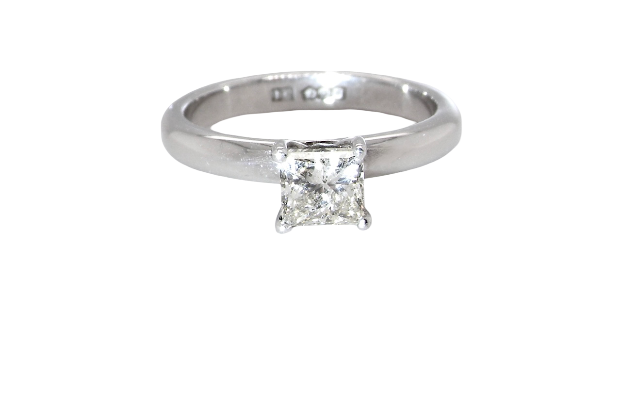 A timeless and beautifully crafted solitaire ring featuring a stunning 0.78 carat Princess-cut white diamond