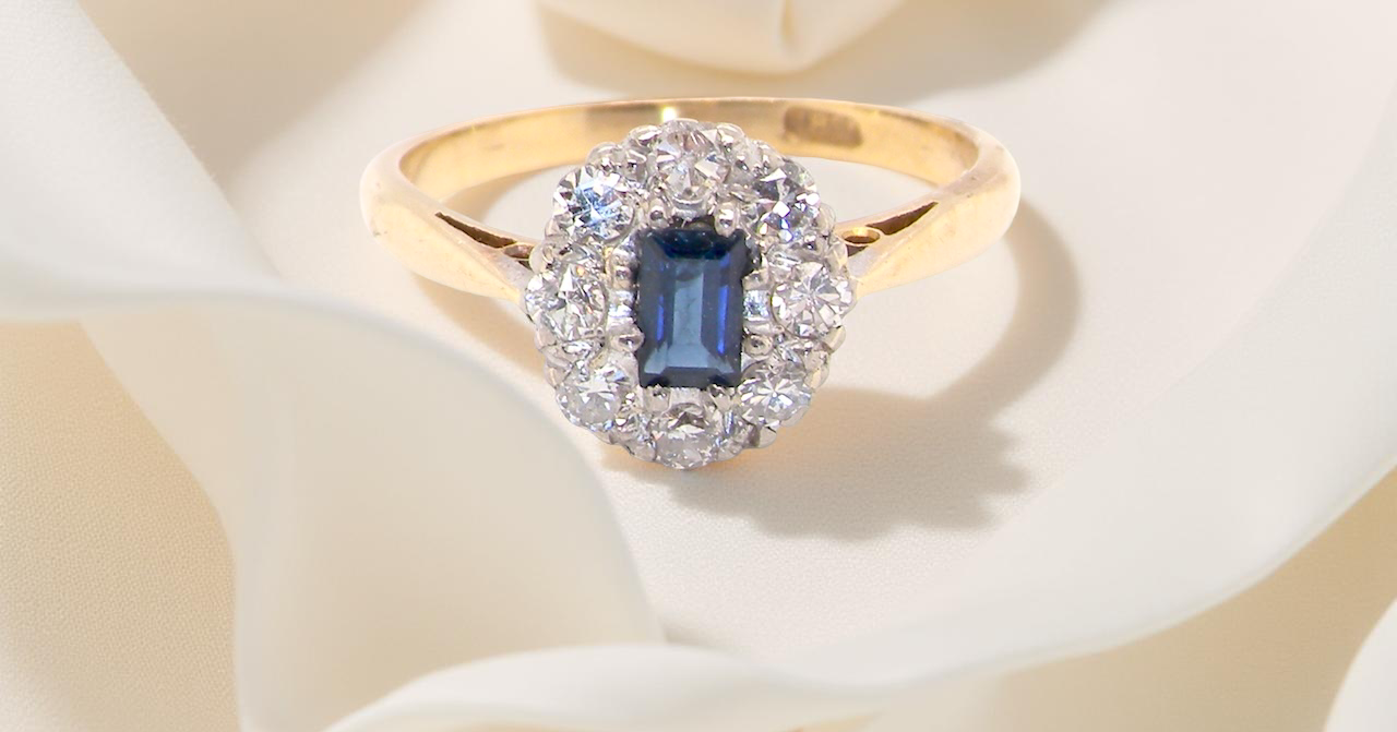 A traditional 1970s cluster ring featuring a rectangular-cut sapphire, A