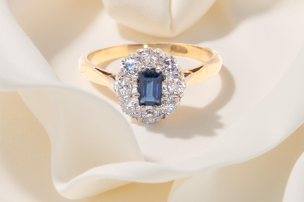 A traditional 1970s cluster ring featuring a rectangular-cut sapphire, A