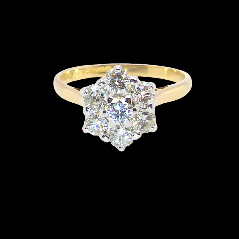 A traditional cluster ring. Features to the centre a 3.4mm brilliant cut white diamond (est 0.15 carats)
Surrounded by 3.4mm diamonds to match