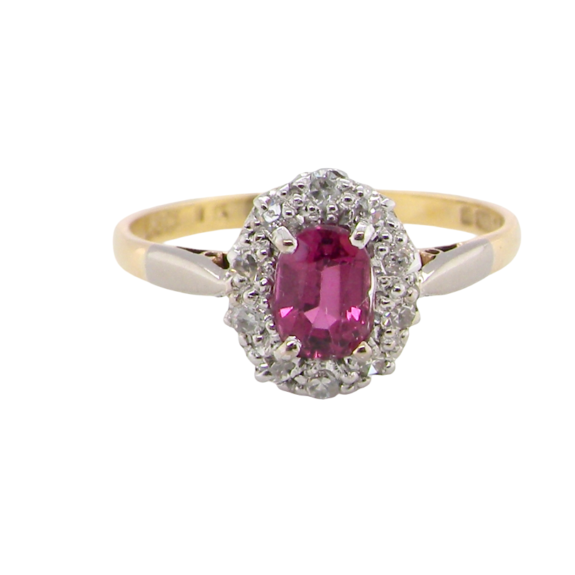 A traditional cluster ring. Features to the centre a dark pink red ruby, oval cut 6x4mm (0.50 carats)