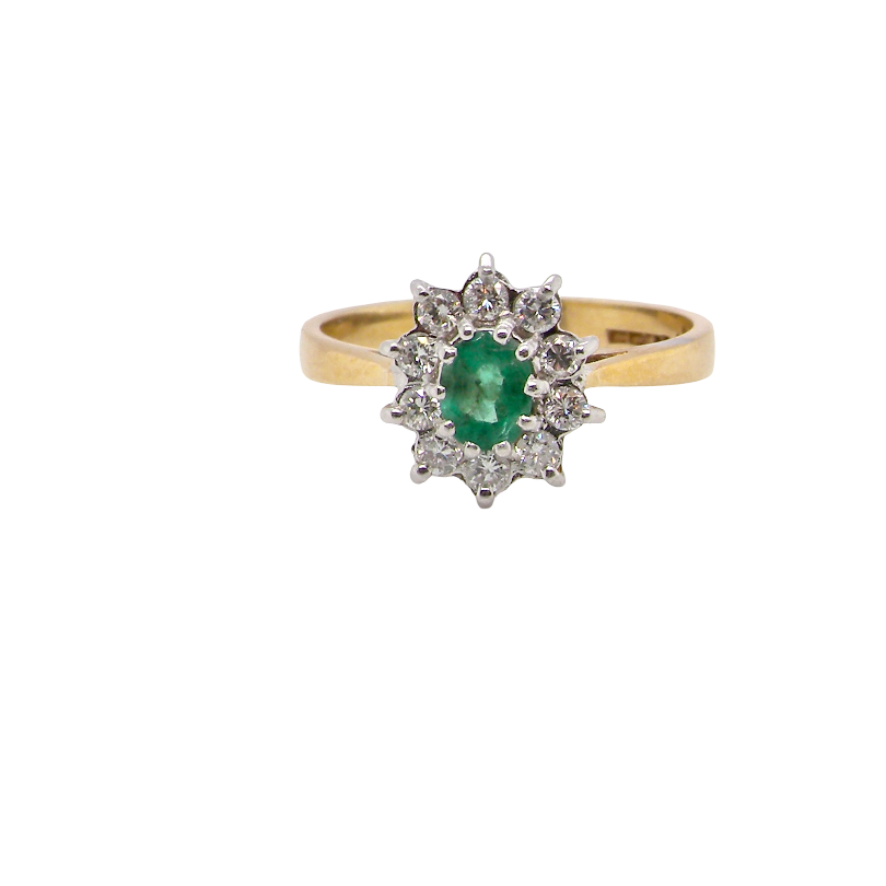 A traditional cluster ring. Features to the centre an oval shaped emerald, 5.5x4.5mm (est 0.35 carats) deep green colour. 