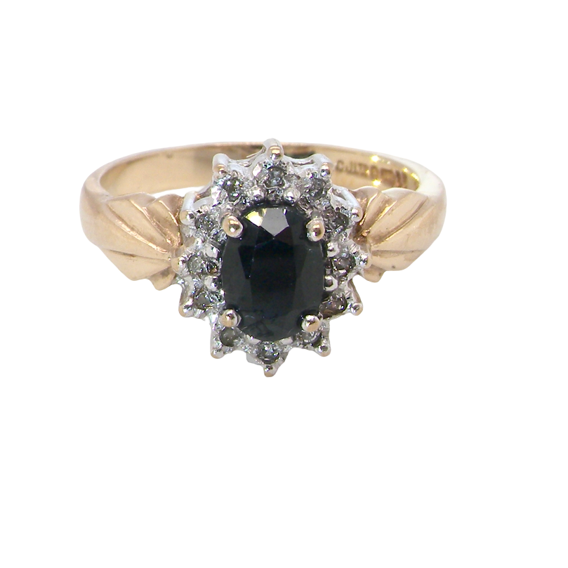 A traditional cluster ring that features to the centre a dark black blue oval cut sapphire 7x5mm claw set.