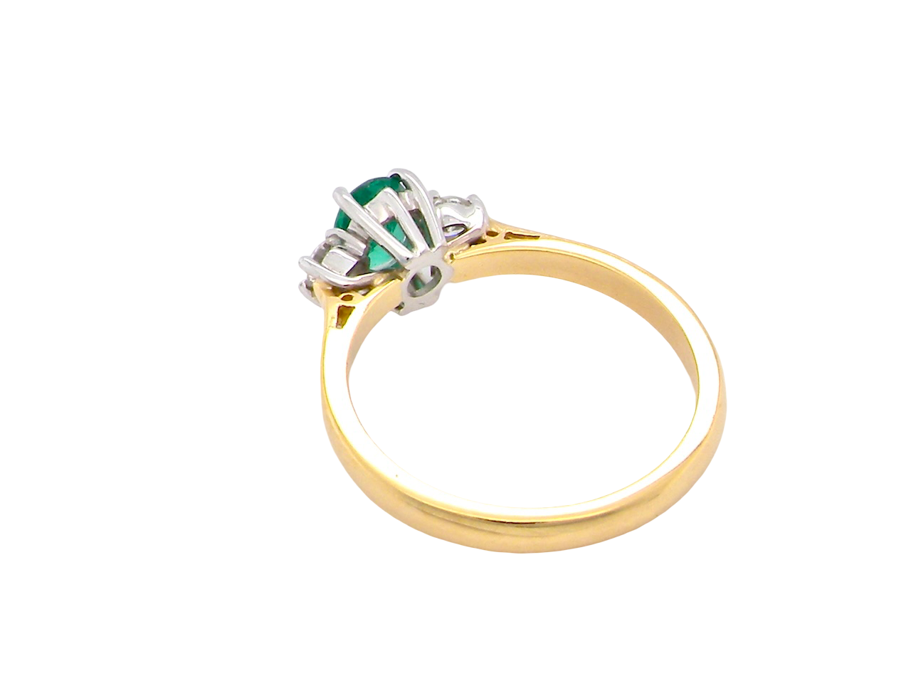 A traditional three stone Emerald and Diamond ring