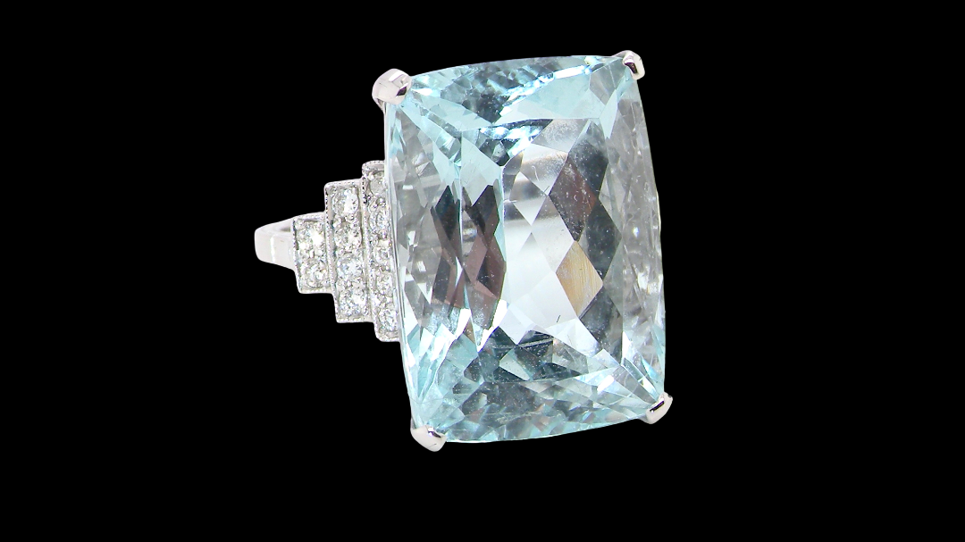 A truly spectacular vintage statement ring, centred with an impressive rectangular-cut aquamarine of exceptional proportions. Measuring approximately 18 x 13mm with a depth of 11mm, the aquamarine is estimated at 18 carats