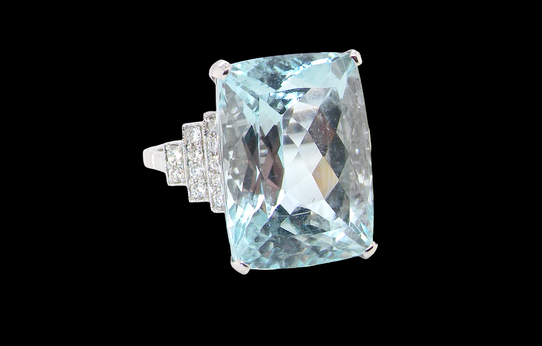A truly spectacular vintage statement ring, centred with an impressive rectangular-cut aquamarine of exceptional proportions. Measuring approximately 18 x 13mm with a depth of 11mm, the aquamarine is estimated at 18 carats