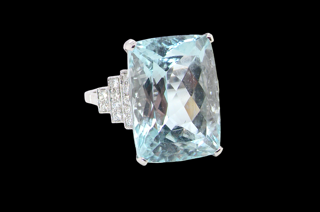 A truly spectacular vintage statement ring, centred with an impressive rectangular-cut aquamarine of exceptional proportions. Measuring approximately 18 x 13mm with a depth of 11mm, the aquamarine is estimated at 18 carats