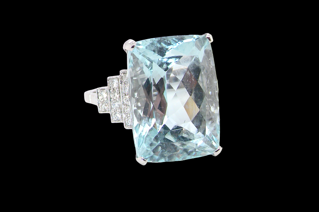 A truly spectacular vintage statement ring, centred with an impressive rectangular-cut aquamarine of exceptional proportions. Measuring approximately 18 x 13mm with a depth of 11mm, the aquamarine is estimated at 18 carats