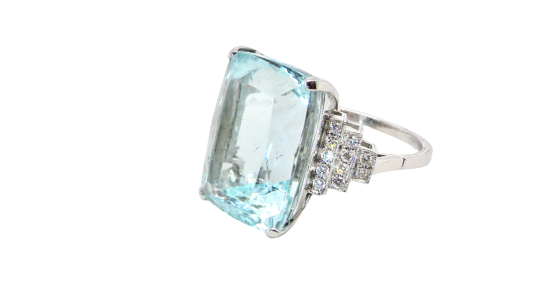 A truly spectacular vintage statement ring, centred with an impressive rectangular-cut aquamarine of exceptional proportions. Measuring approximately 18 x 13mm with a depth of 11mm, the aquamarine is estimated to weigh around 18 carats side