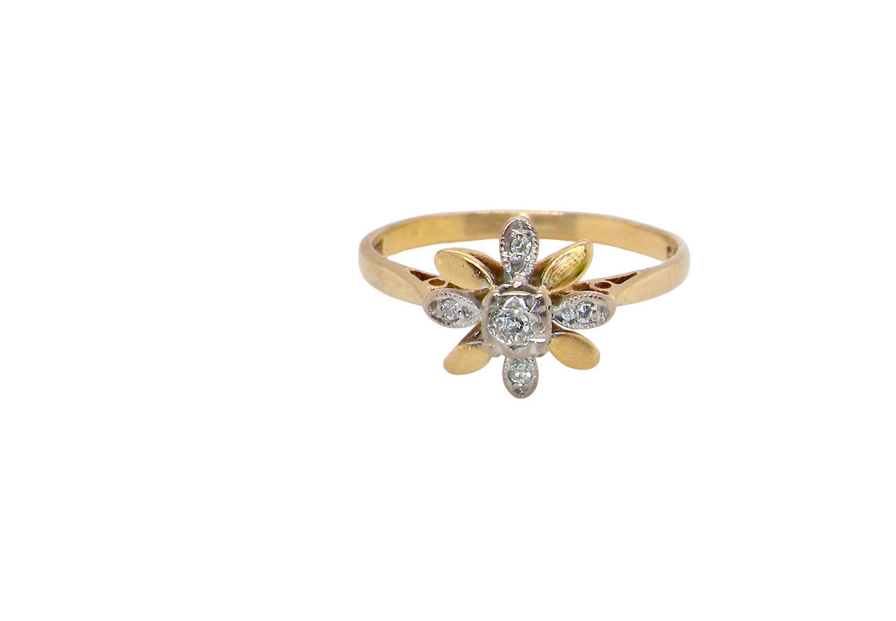 A very pretty cluster ring, a design from the 1950s. Its daisy style was popular during this period, and set with five small white diamonds ( set into platinum.