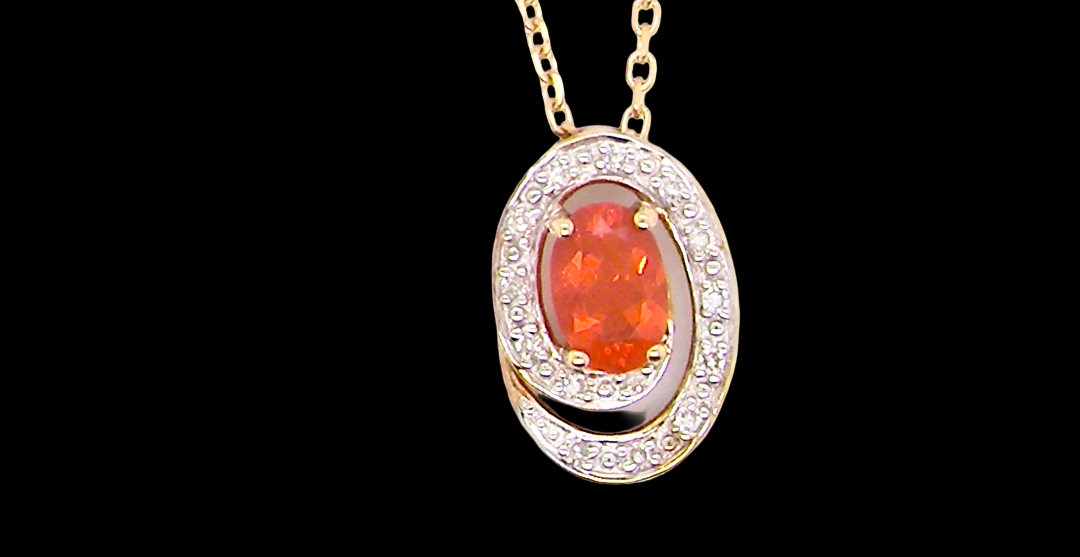 A very pretty pendant set with a fireglow orange Fire Opal. 