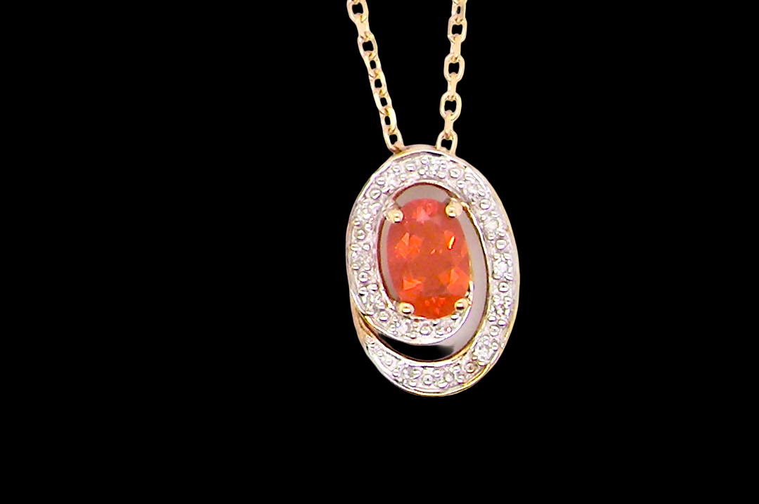 A very pretty pendant set with a fireglow orange Fire Opal. 