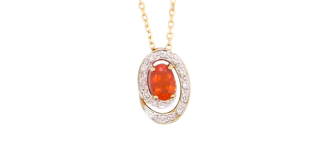 A very pretty pendant set with a fireglow orange Fire Opal. Measures 6x4mm
