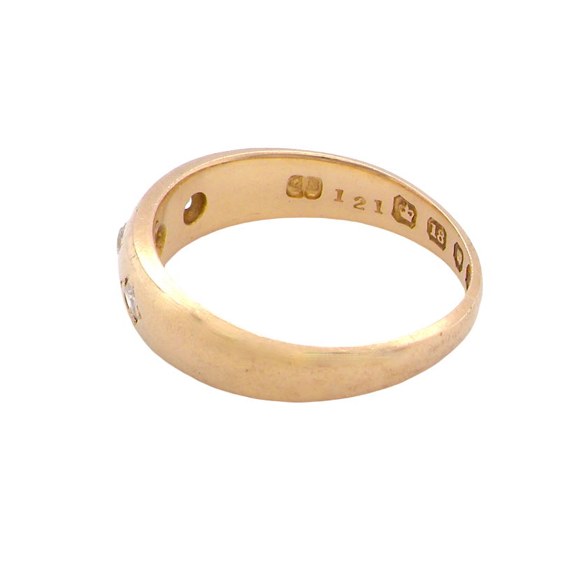 A vintage 18 carat gold three stone ring. Set with brilliant cut white diamonds, cente 3mm, each side a 2.4mm diamond (total est 0.20 carats) Colour I-j, clarity Si.
side