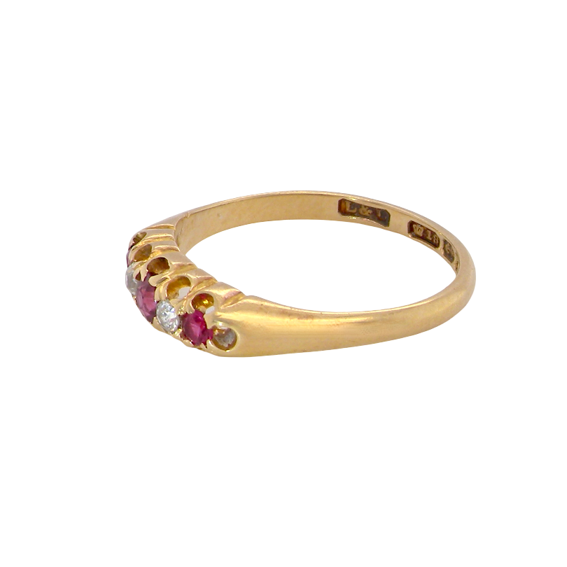 A vintage 18 carat gold three stone ring. Set with brilliant cut white diamonds, cente 3mm, each side a 2.4mm diamond (total est 0.20 carats) Colour I-j, clarity Si.
side
