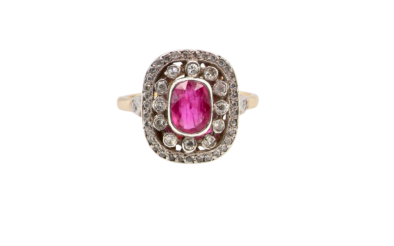 Ring with a pink gemstone and diamond accents on a white background