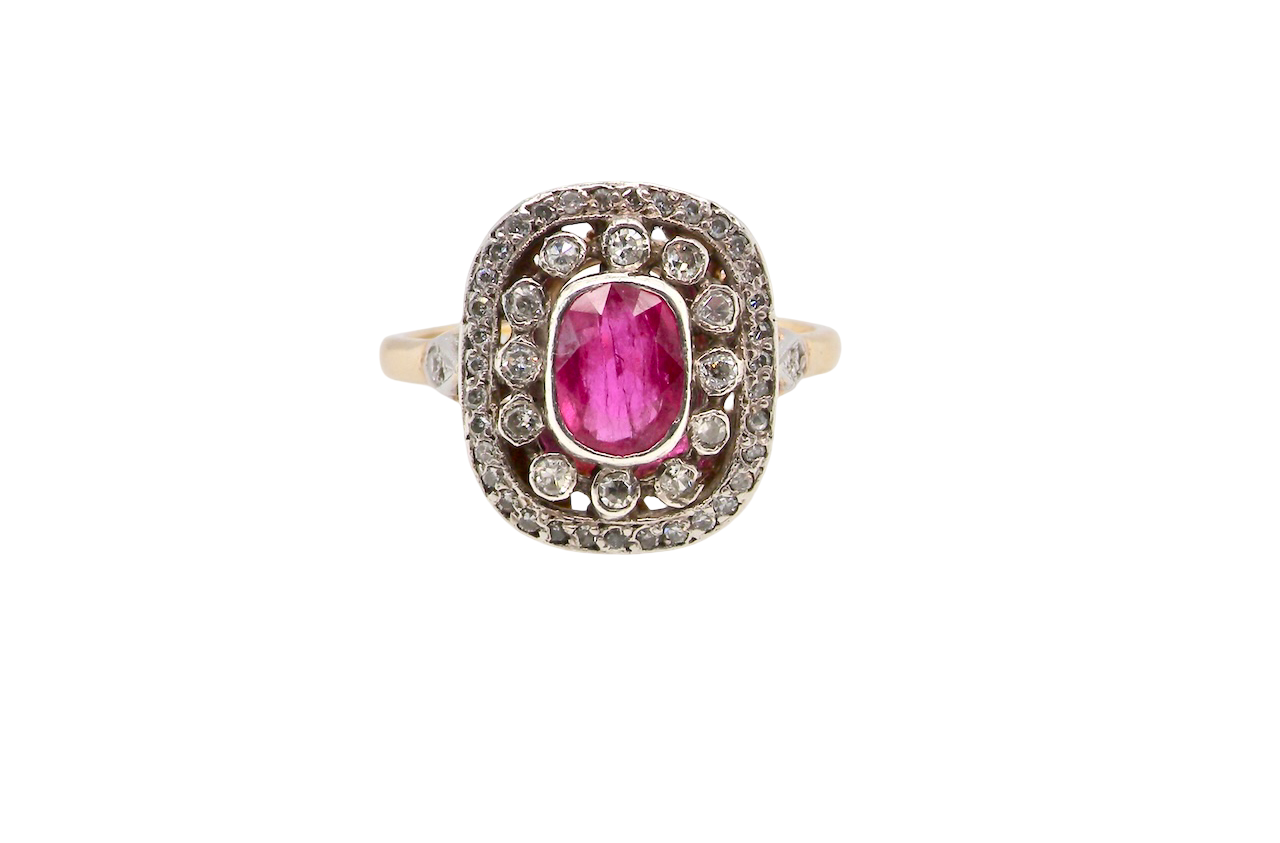 Ring with a pink gemstone and diamond accents on a white background