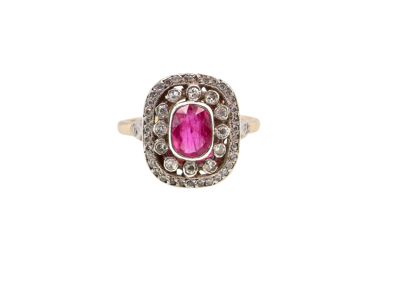 Ring with a pink gemstone and diamond accents on a white background