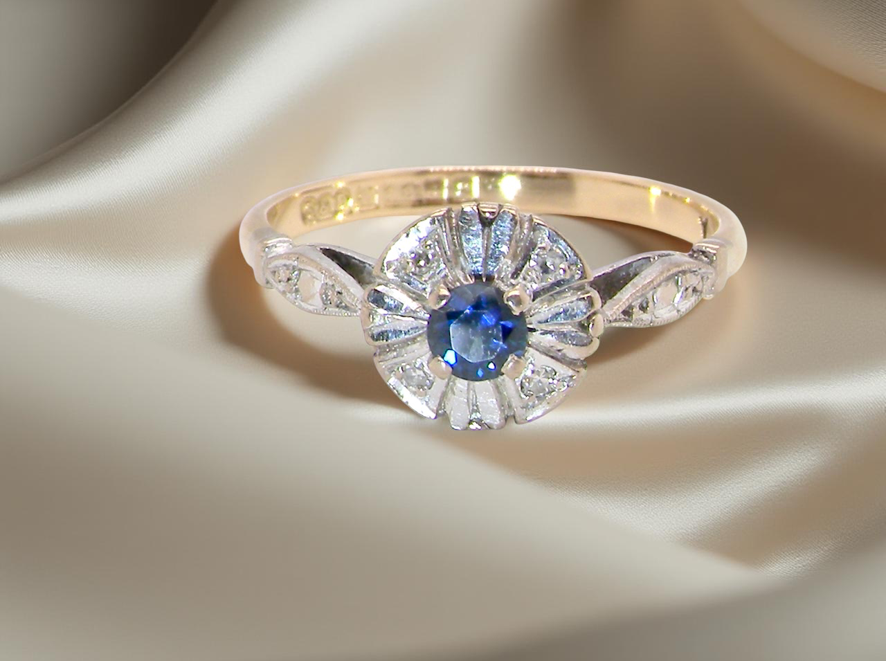 A vintage cluster ring featuring a ;black-blue sapphire