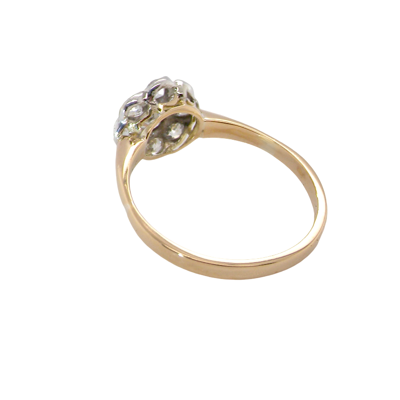 A yellow gold ring with a cluster of small clear gemstones at the top, shown on a plain white background.
