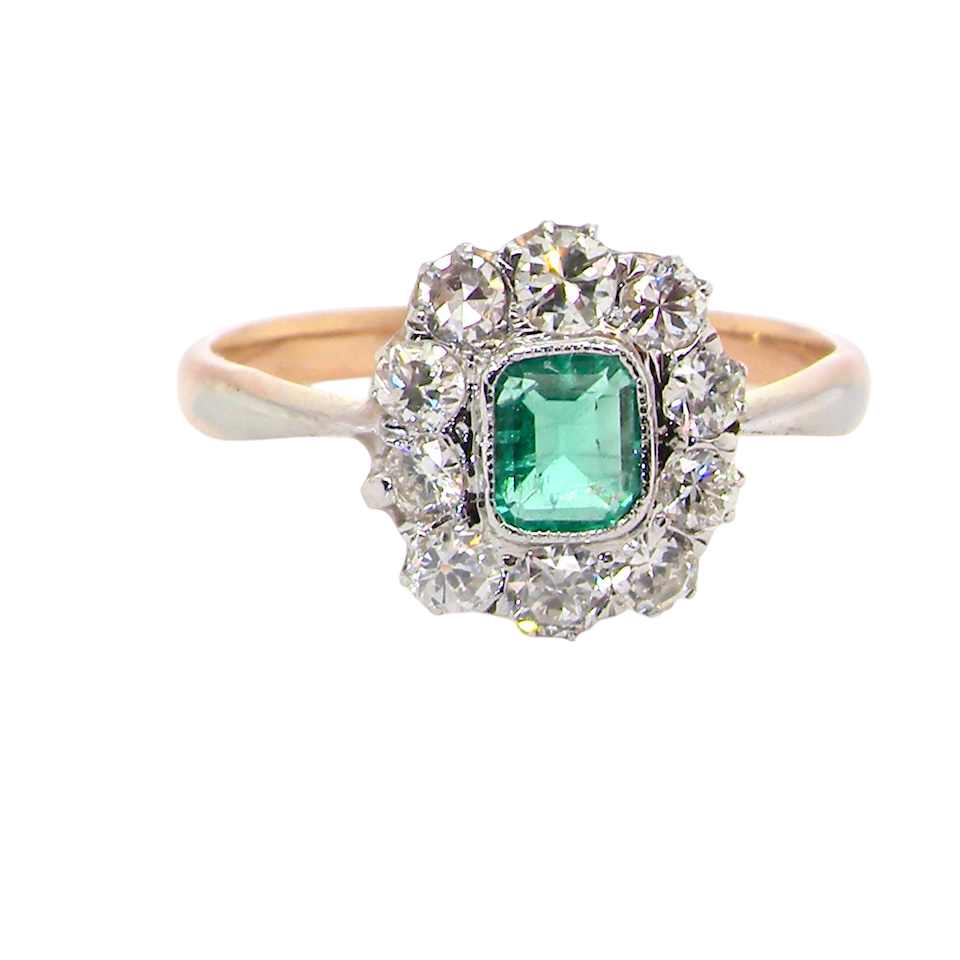 A vintage cluster ring, the centre stone a cushion shaped emerald 4x3.5mm, mid to dark green colour.