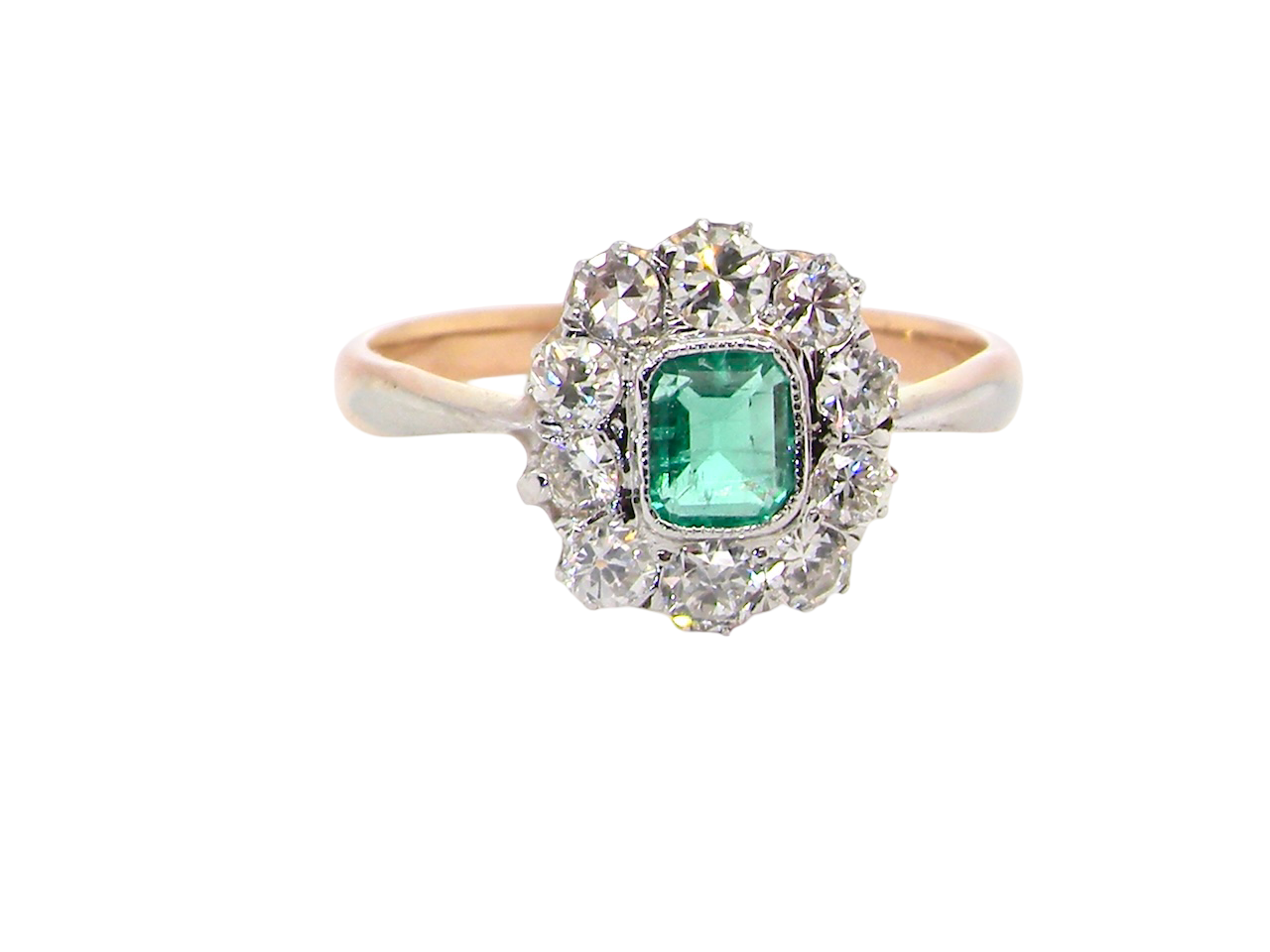 A vintage cluster ring, the centre stone a cushion shaped emerald 4x3.5mm, mid to dark green colour.