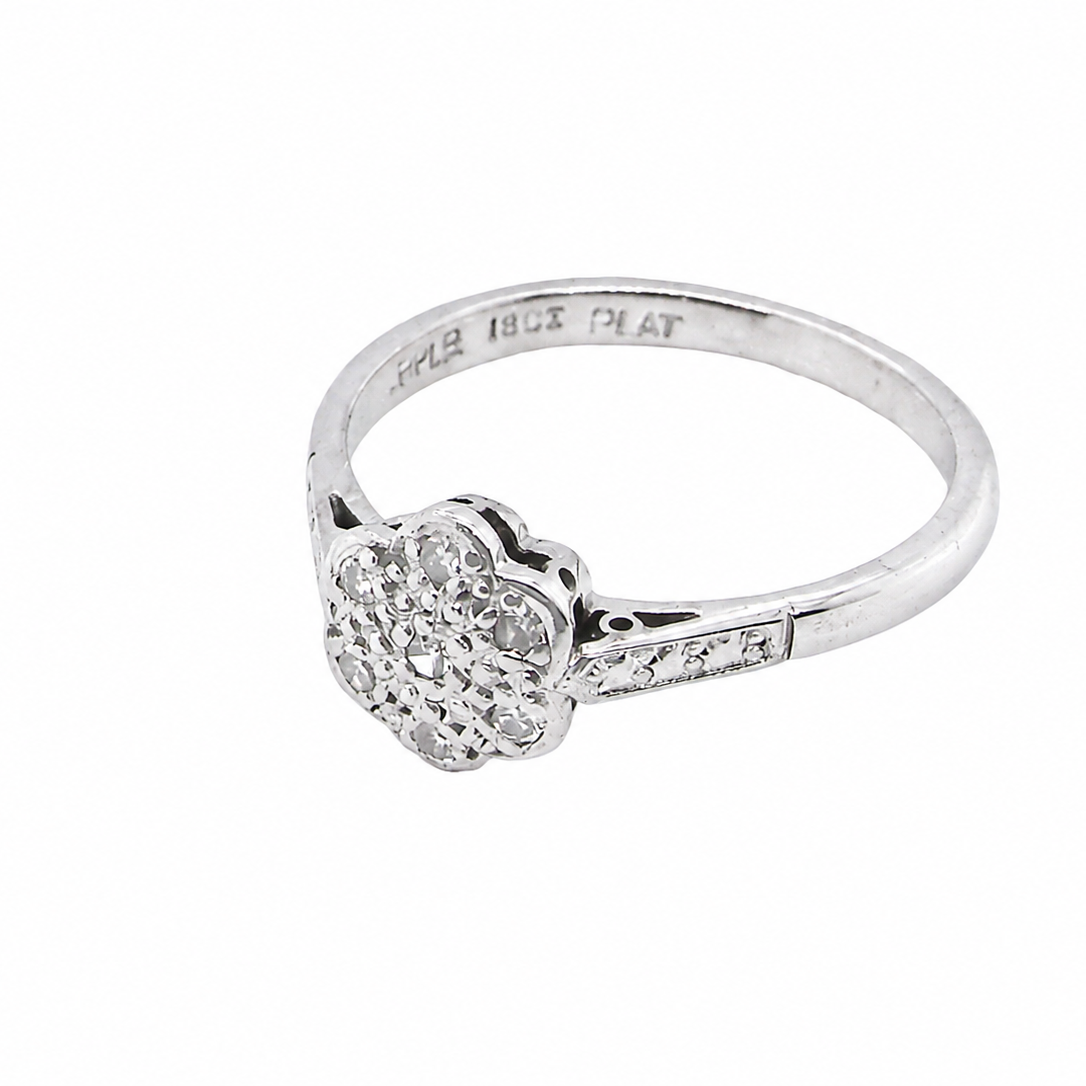 A vintage cluster ring, the head set with seven small single cut white diamonds, each 1.7mm