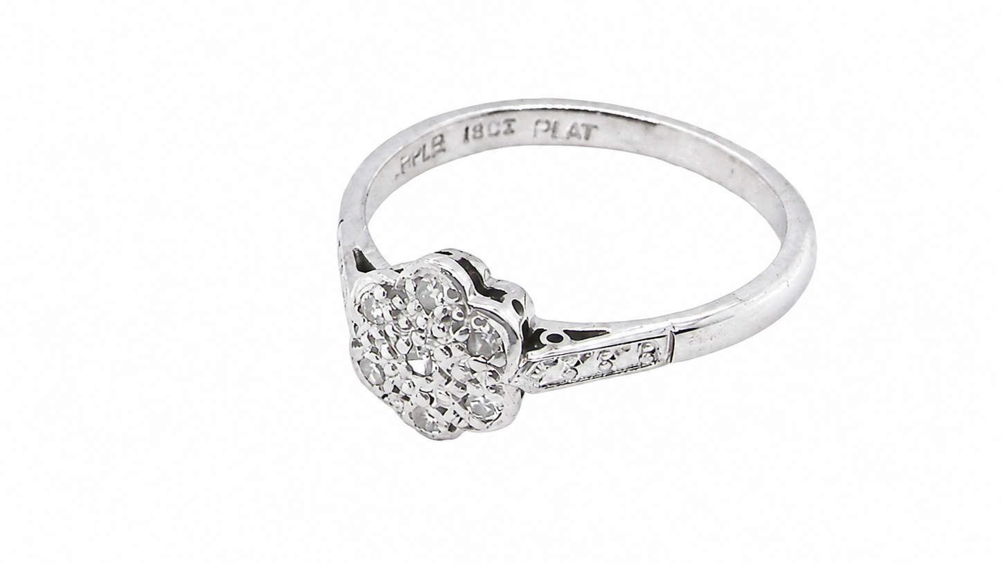 A vintage cluster ring, the head set with seven small single cut white diamonds, each 1.7mm