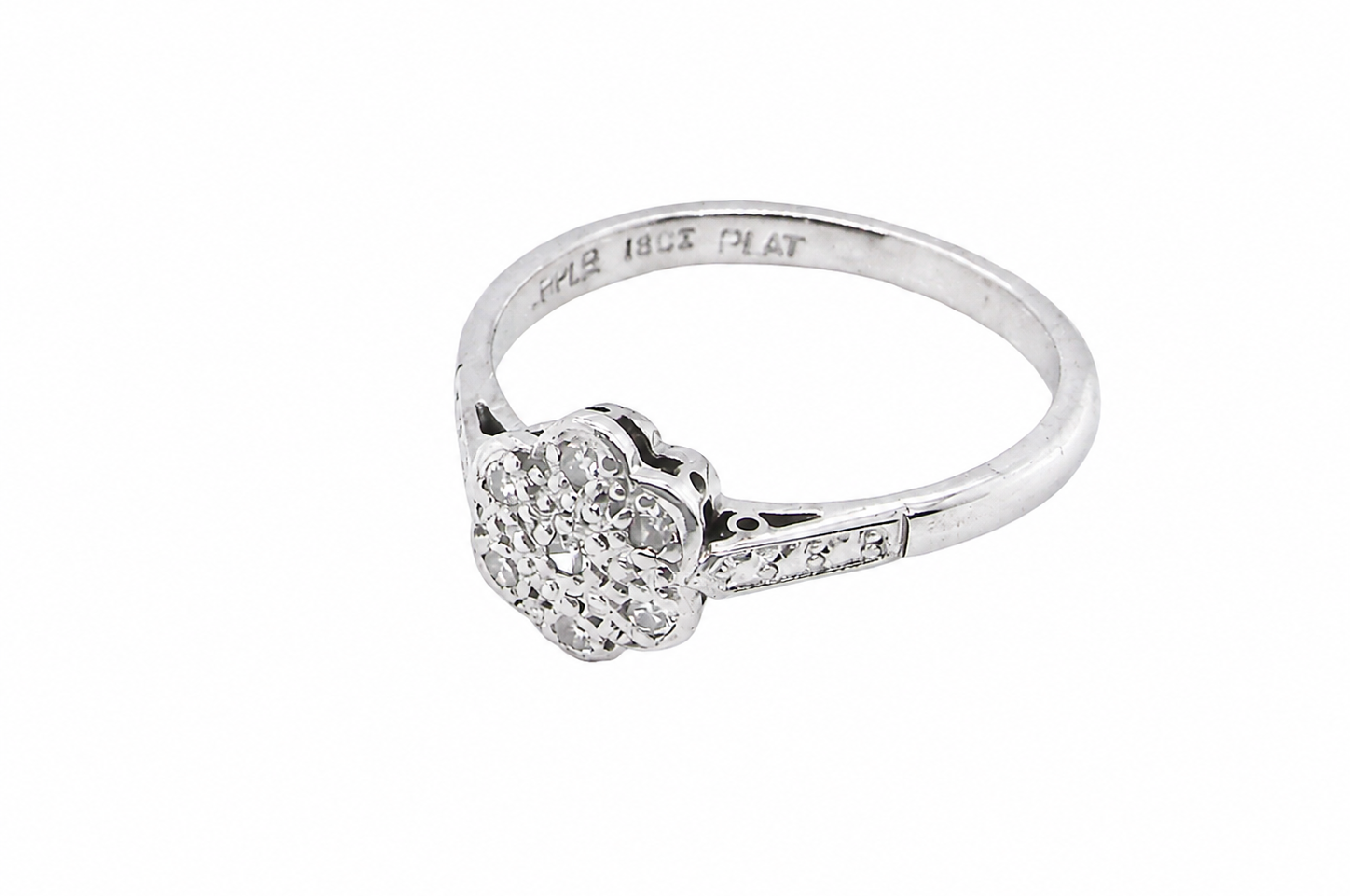 A vintage cluster ring, the head set with seven small single cut white diamonds, each 1.7mm