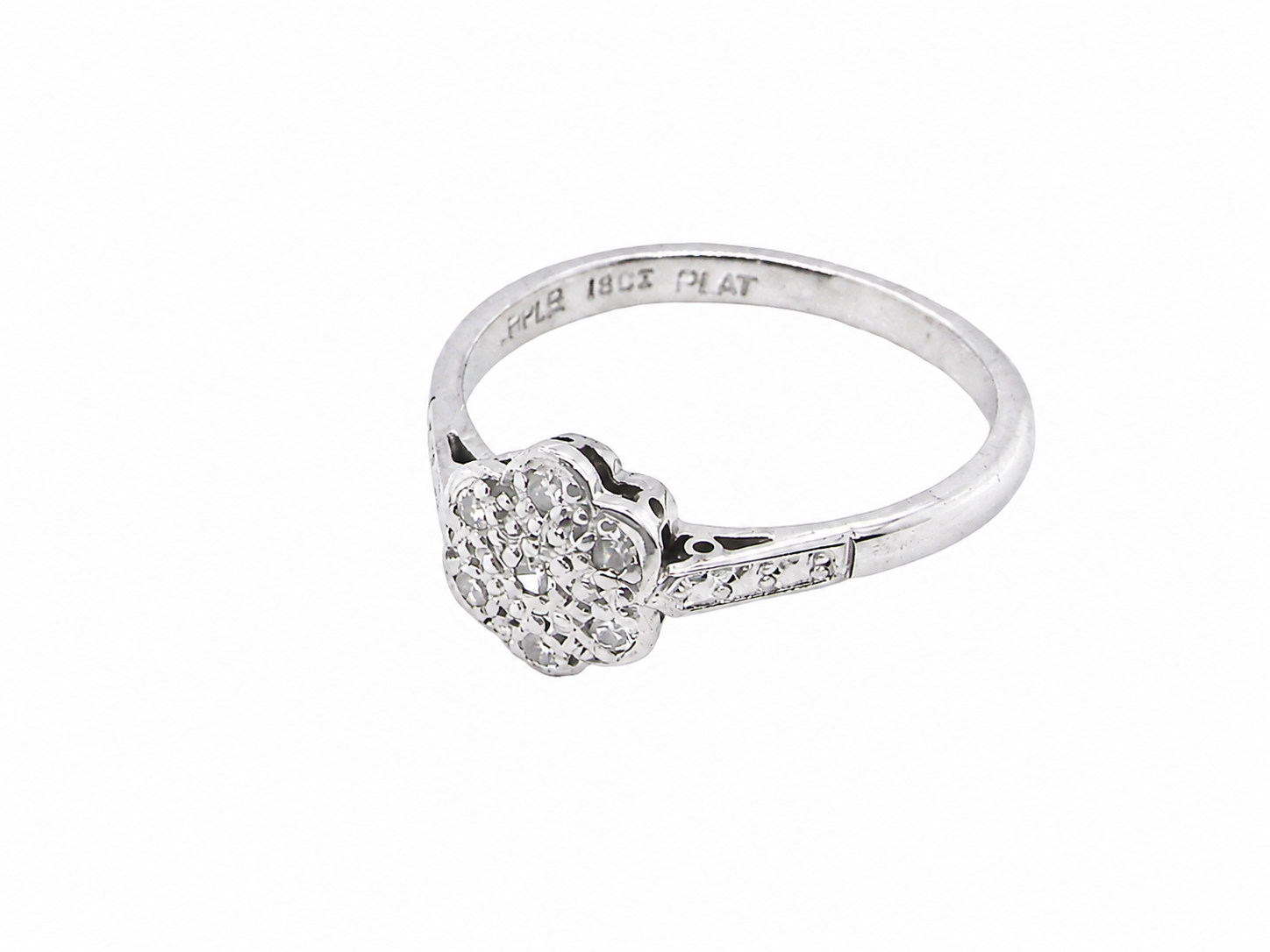 A vintage cluster ring, the head set with seven small single cut white diamonds, each 1.7mm