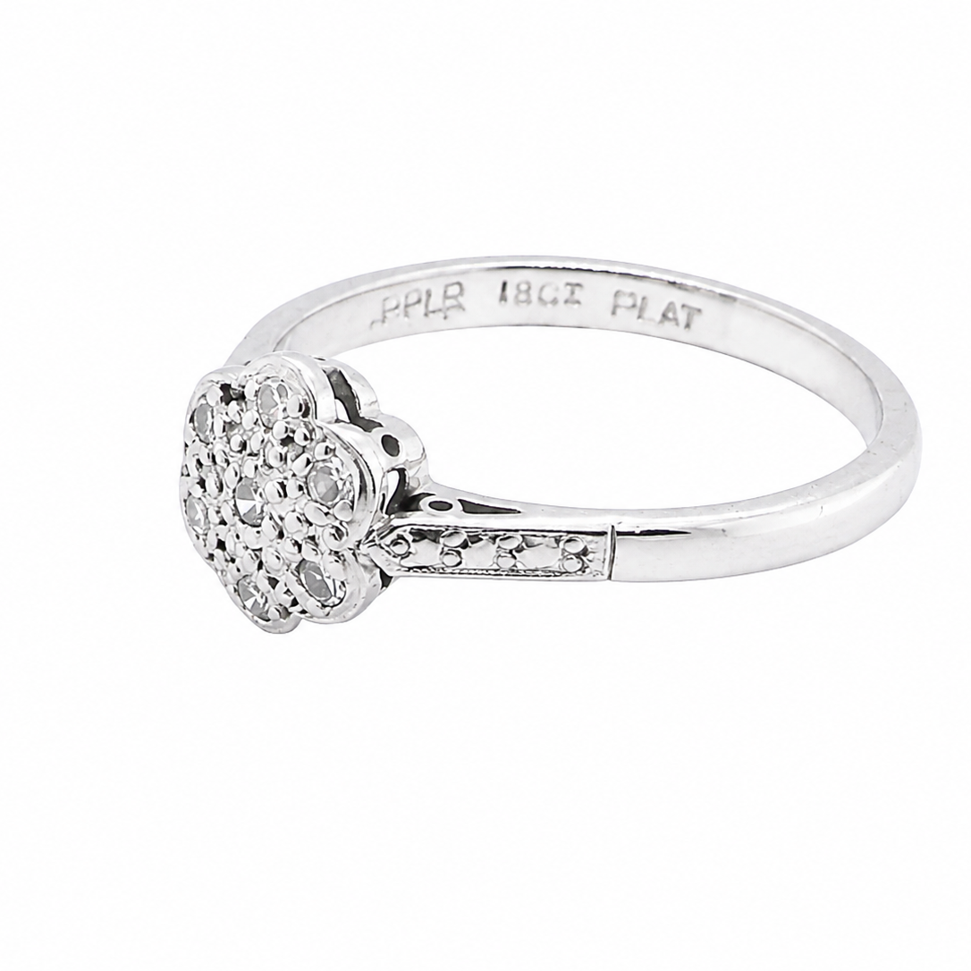 A vintage cluster ring, the head set with seven small single cut white diamonds, (est 0.15 carats)