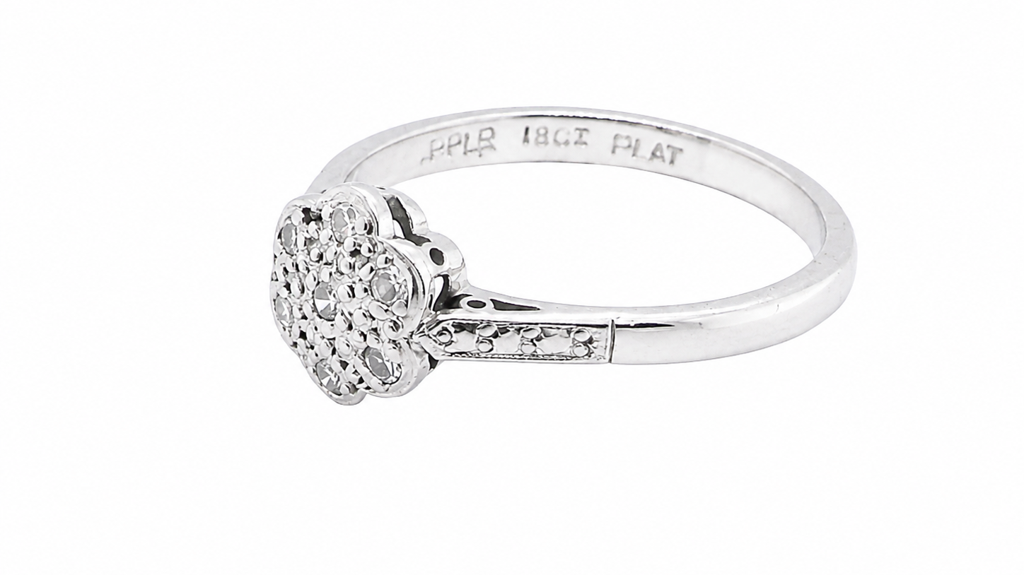 A vintage cluster ring, the head set with seven small single cut white diamonds, (est 0.15 carats)