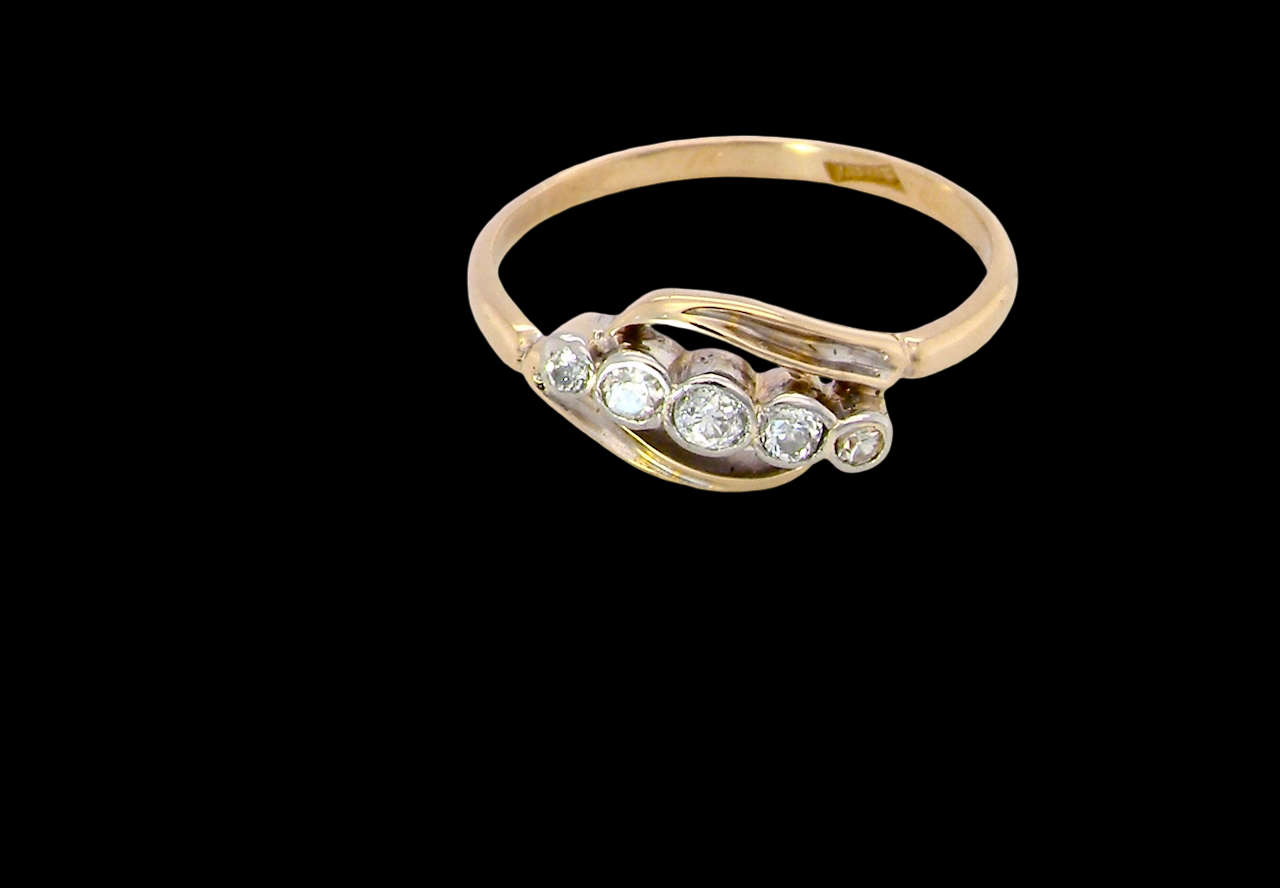 A vintage cross over style ring. Set with five old brilliant cut white diamonds. Centre stone 3mm, each side 2.4mm, each end 1.5mm. Total diamonds at 0.22 carats.
