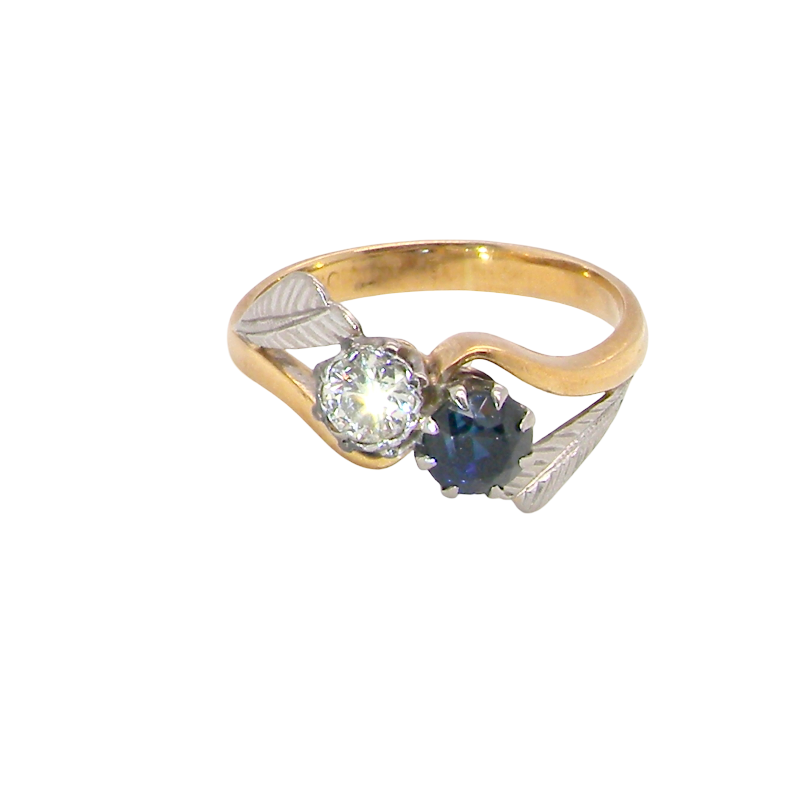 A vintage crossover ring. Set with a round sapphire 5mm diameter, black blue colour.