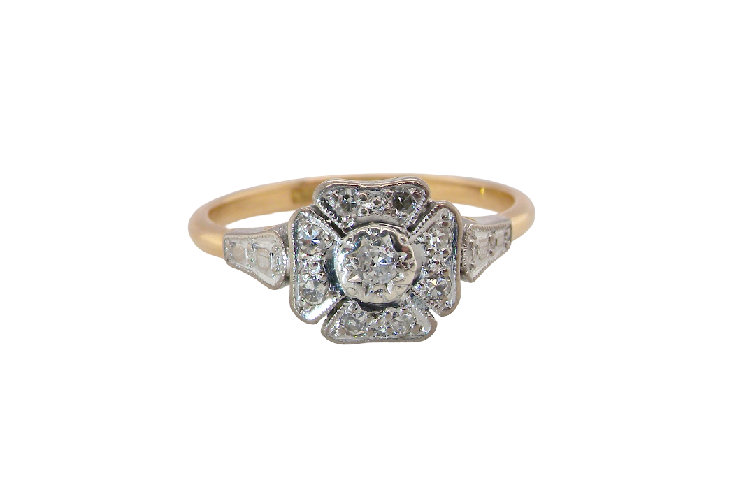 A vintage diamond cluster ring. Shaped like a four leaf clover, each leaf is pavé set with small white diamonds, two each x 1.5mm. Centre diamond 2.4mm.