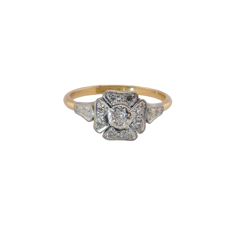 A vintage diamond cluster ring. Shaped like a four leaf clover, each leaf is pavé set with small white diamonds, two each x 1.5mm. Centre diamond 2.4mm. (total estimated total 0.17 carats)