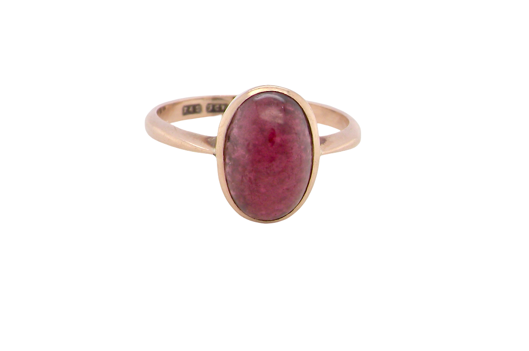 A vintage dress ring. Set with an oval cabouchon cut garnet, 11x7mm, i