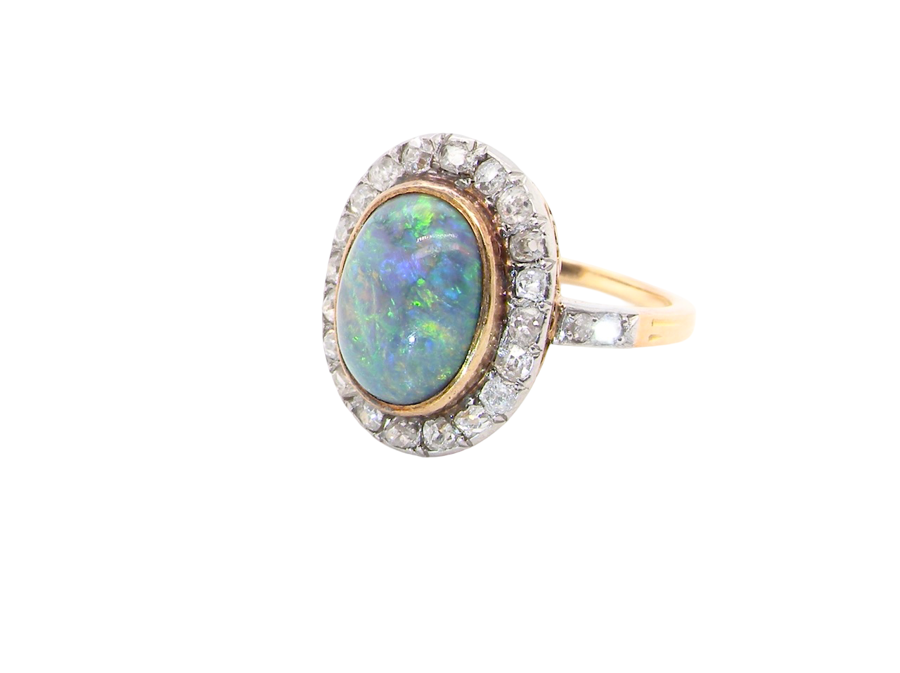 A vintage early 20th century cluster ring. Features to the centre a black opal doublet,