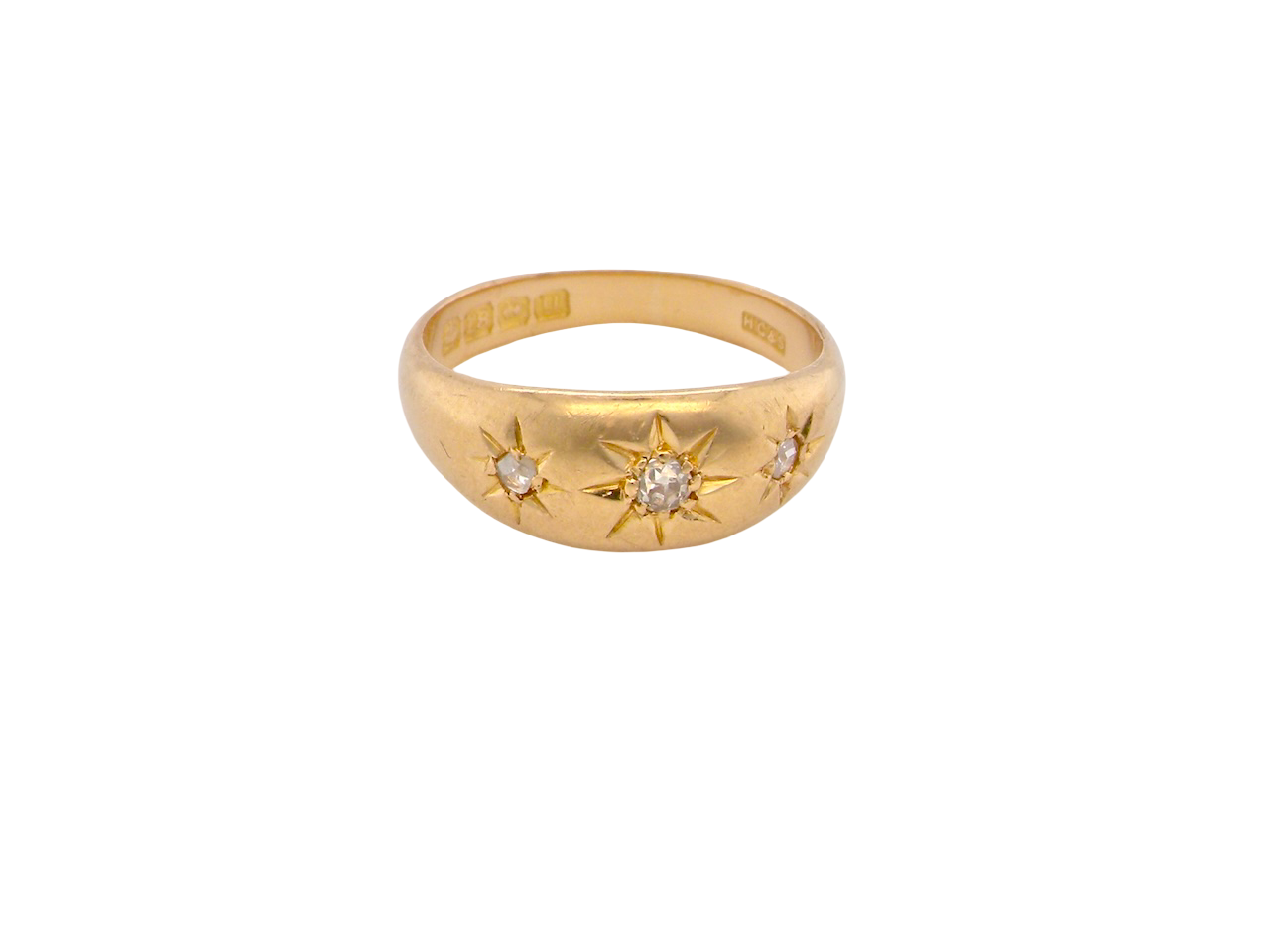 Gold ring with star designs and small diamonds on a white background