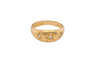 Gold ring with star designs and small diamonds on a white background