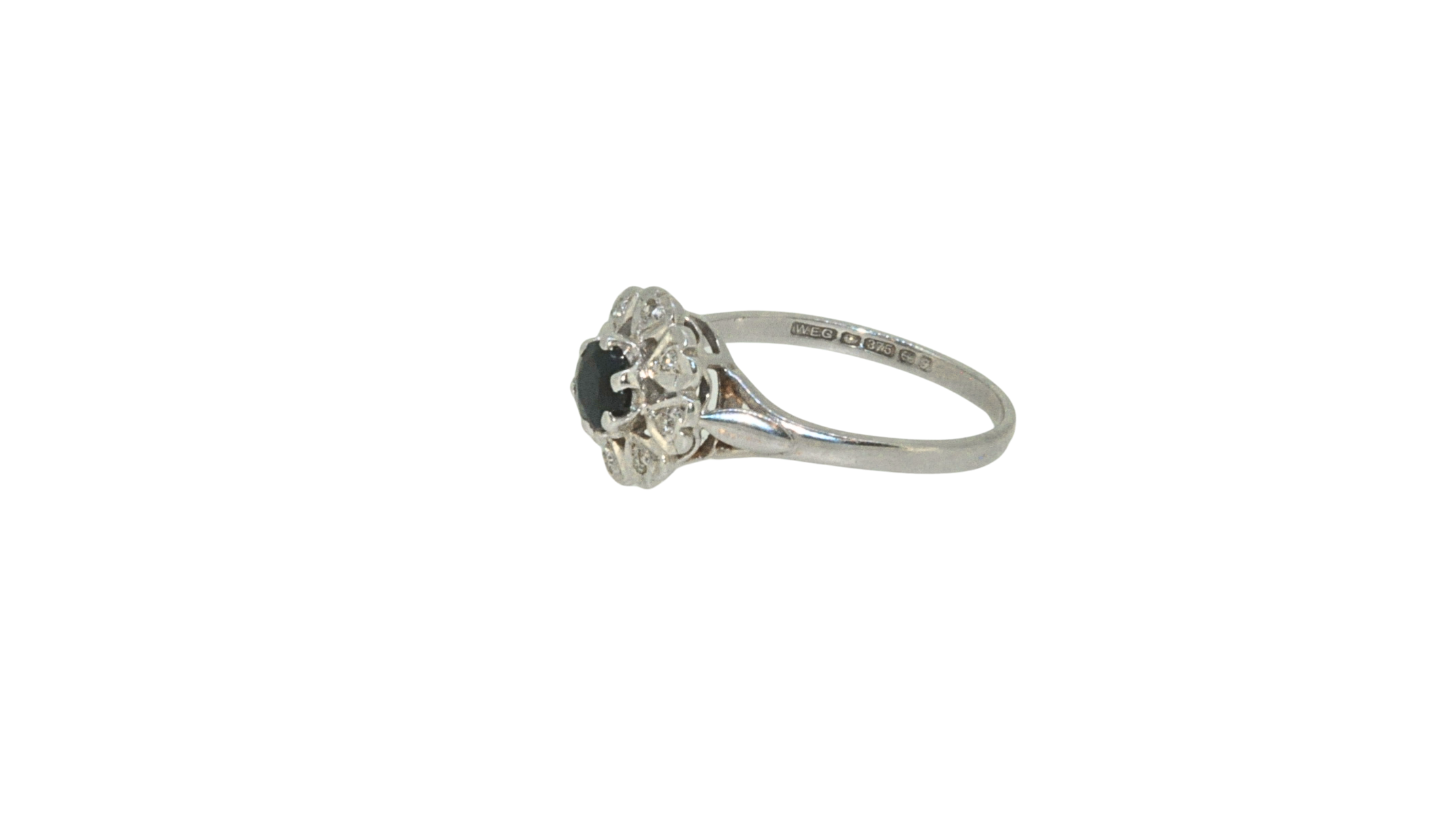 Hallmarked side view of sapphire and diamond cluster ring