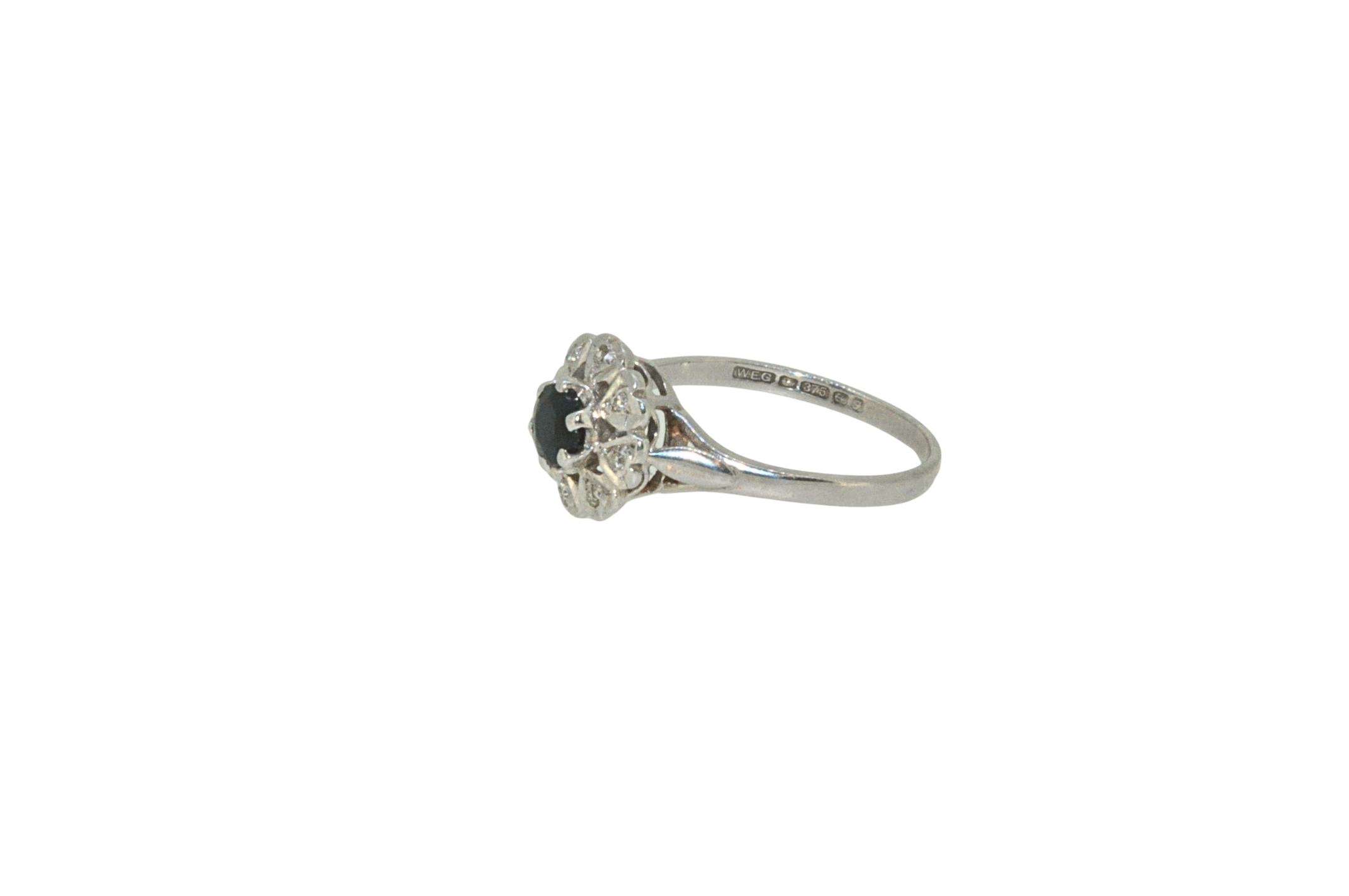 Hallmarked side view of sapphire and diamond cluster ring