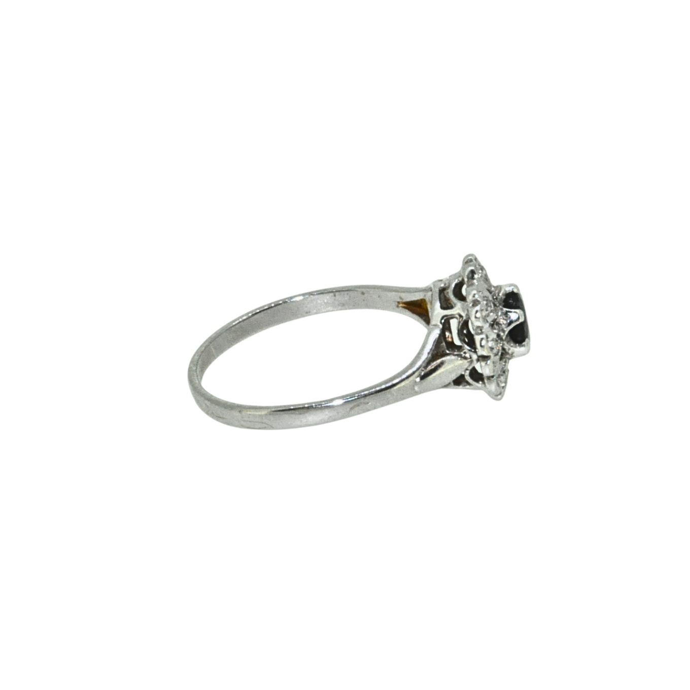 Side view of sapphire and diamond cluster ring