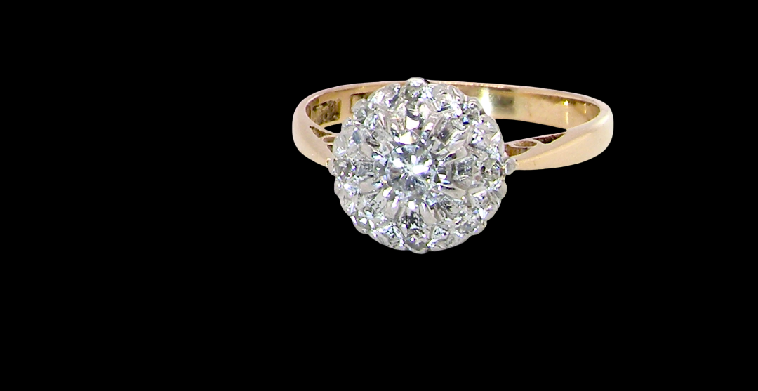 A vintage mid 20th century cluster ring. Principle stone a brilliant cut white diamond, 4mm