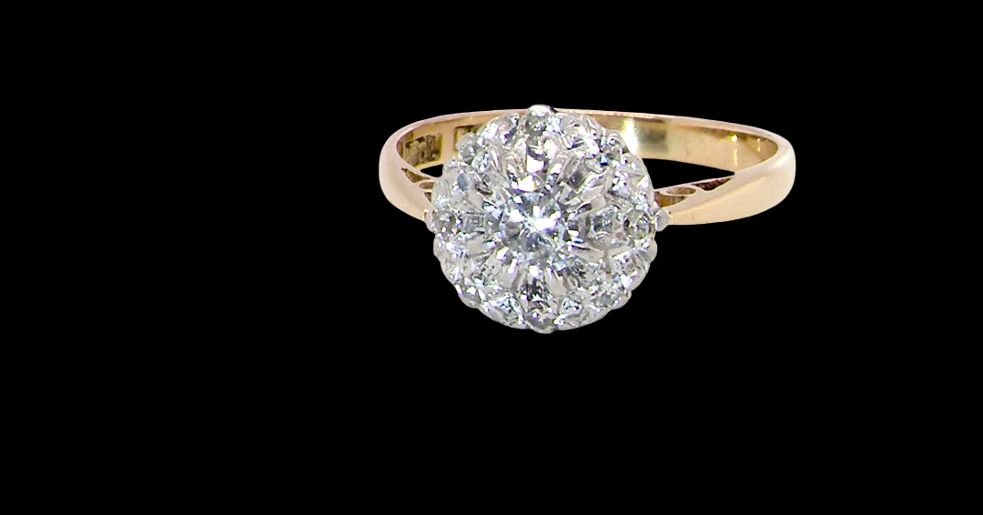 A vintage mid 20th century cluster ring. Principle stone a brilliant cut white diamond, 4mm