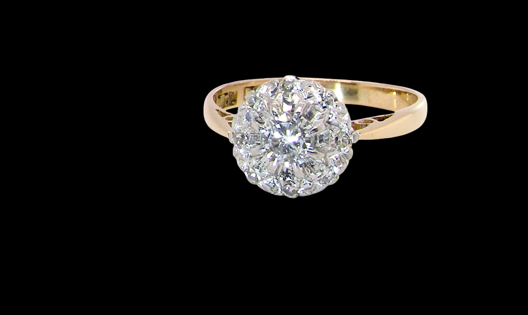 A vintage mid 20th century cluster ring. Principle stone a brilliant cut white diamond, 4mm